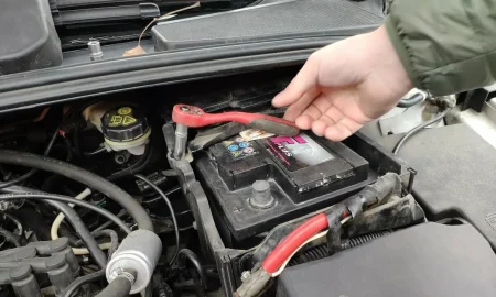 men_replacing_old_car_battery_before it_dies.webp